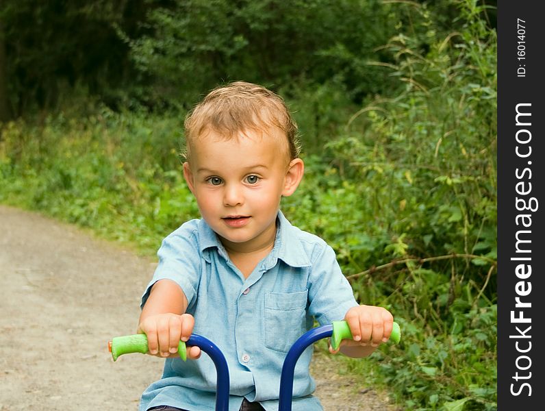 Boy riding bicycle in forest. Boy riding bicycle in forest