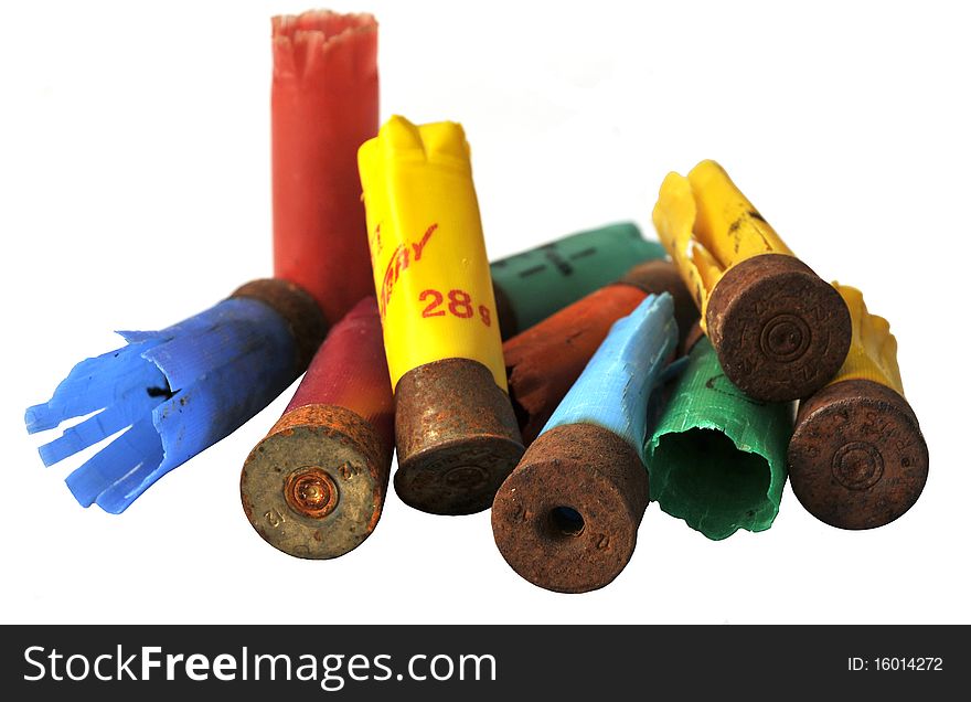 Multi-colored used cartridge cases on white background. Multi-colored used cartridge cases on white background