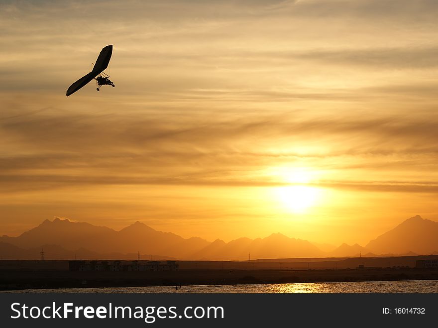 Hang-glider flight on sunset in Egypt. Hang-glider flight on sunset in Egypt