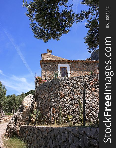 Smal finca with stone wall in sierra de tramuntana near soller, mallorca