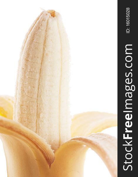 Closeup view of peeled banana isolated over white.