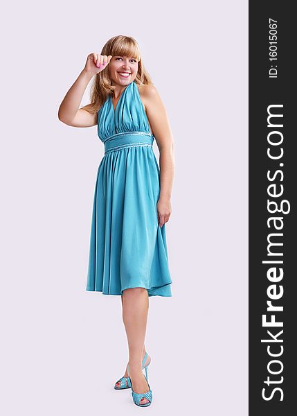 Girl in a blue long dress on a light grey background