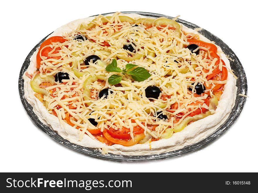 Uncooked vegetarian pizza isolated on white background
