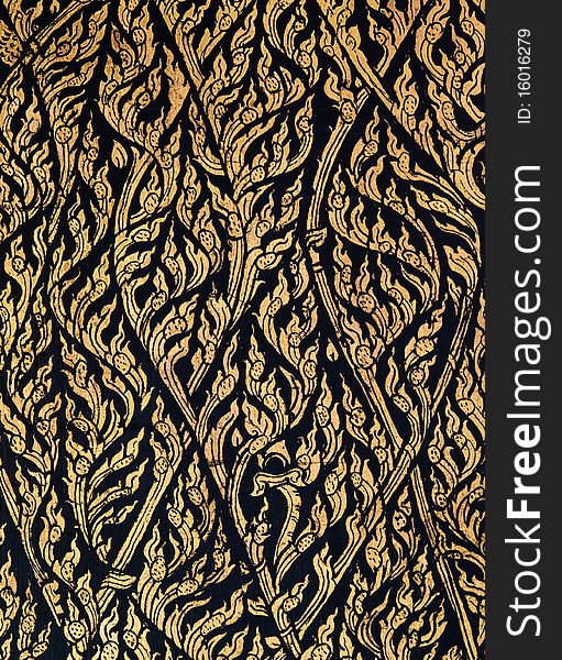 Laithai make from gold on black wall