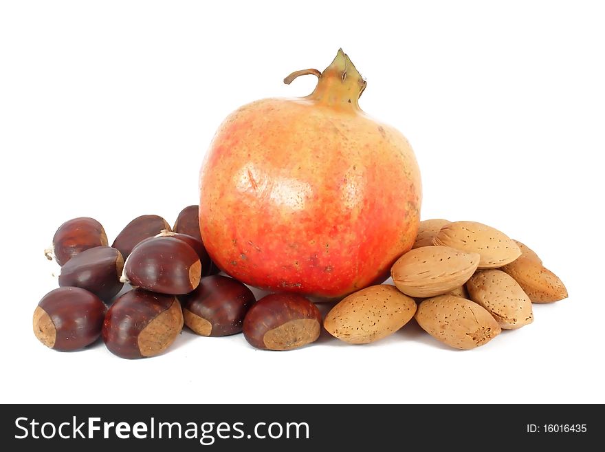 Pomegranate, chestnuts and almonds, isolated on white