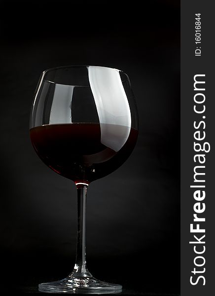 Glass of red wine on a dark background