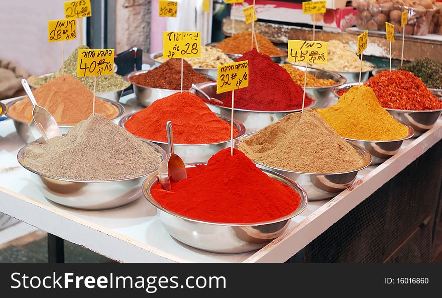 Colorful spices in bowls on market stand