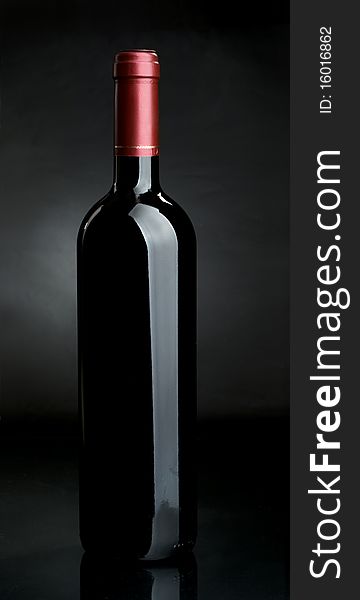 Bottle of red wine on a dark background