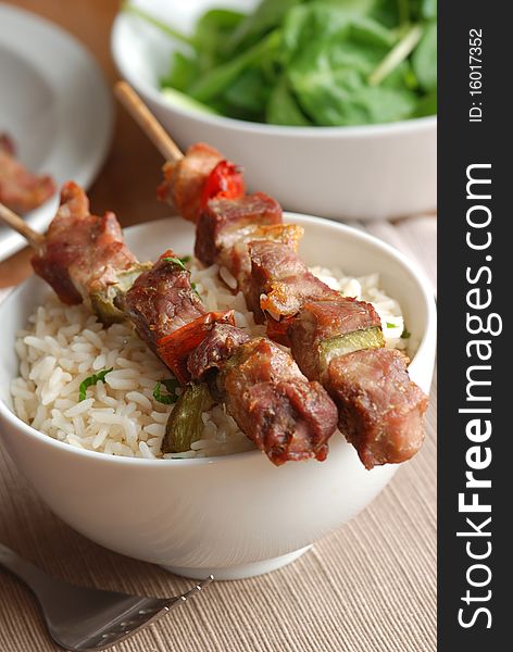 Pork skewers with rice in a bowl