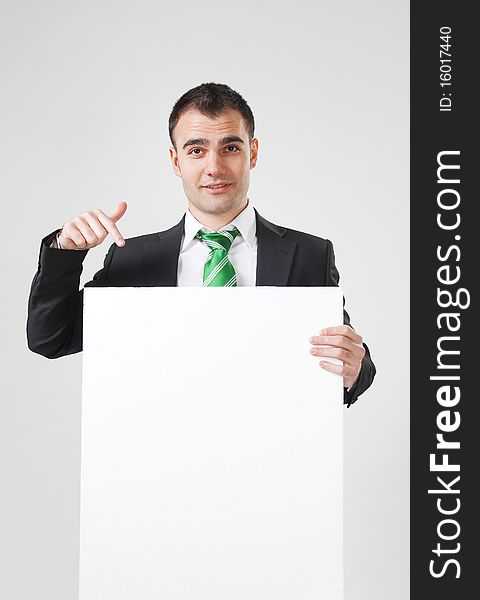 Businessman pointing to white blank card