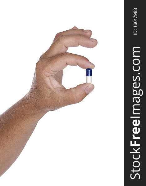 Hand is holding a pill isolated on white background