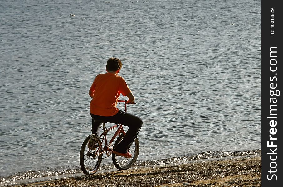 Boy riding a bicycle on a beach