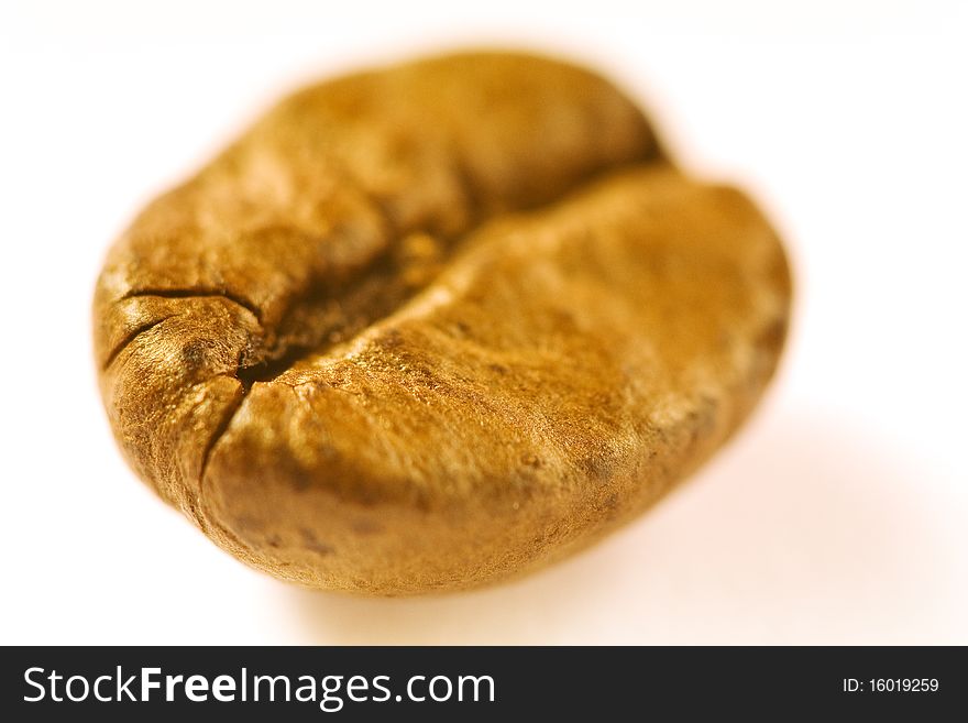 Macro of a brown good smelling coffeebean on white ground. Macro of a brown good smelling coffeebean on white ground
