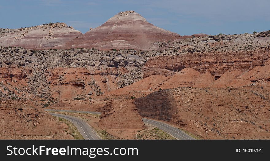 A four lane highway traveling through desert mountains. A four lane highway traveling through desert mountains.