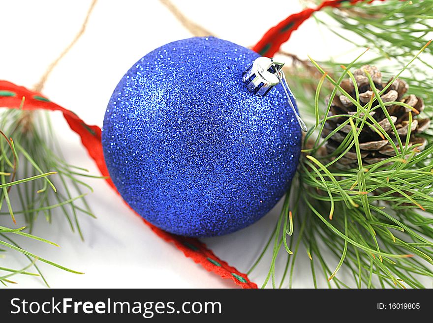 A blue ornament with tree branch.