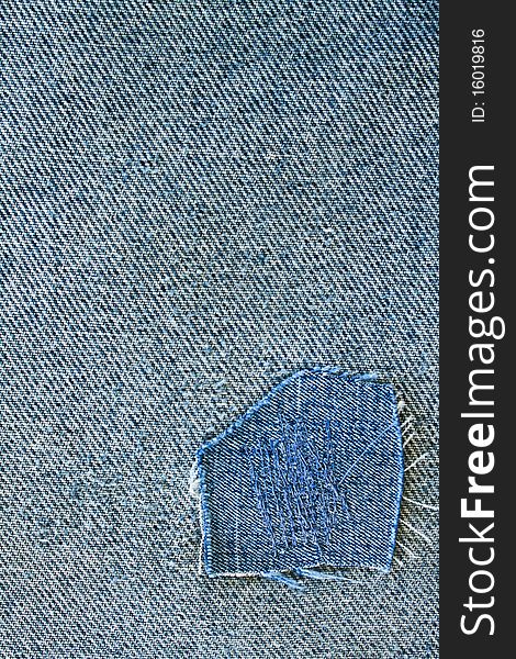 Fragment of blue modern jeans with patch, can be used as a background