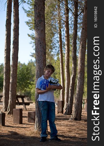 A boy with a balloon and a gift (a bouquet of flowers) on the background of nature. A boy with a balloon and a gift (a bouquet of flowers) on the background of nature.