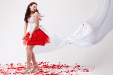 Young Beautiful Woman With Petals Of Roses Stock Photo