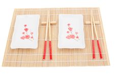 Sushi Plates And Chopsticks On Bamboo Mat Stock Images