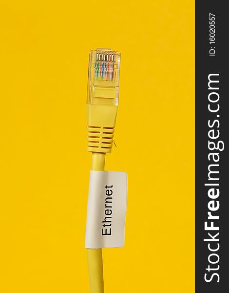 Close up of Ethernet Cable on a yellow background