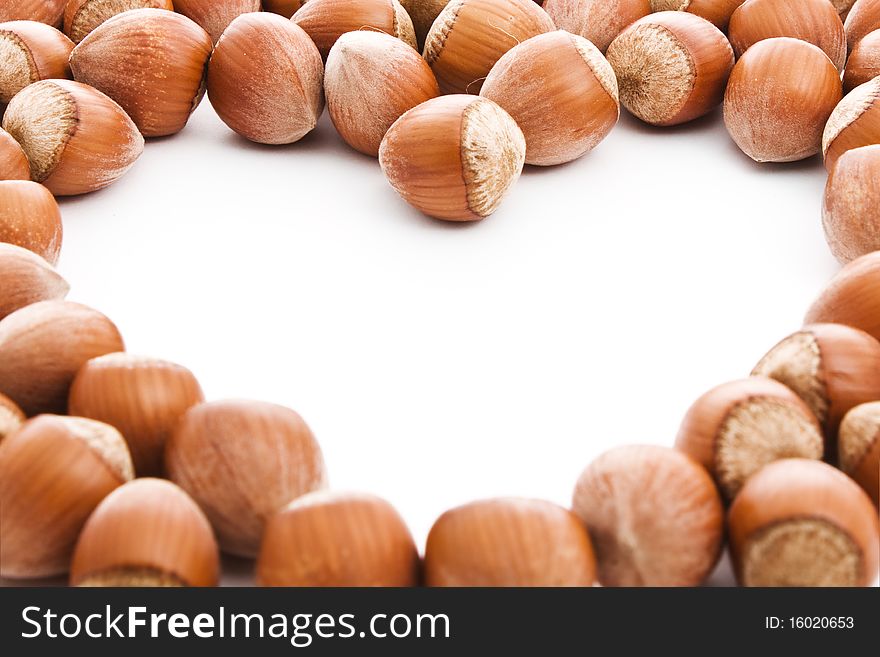 Hazelnuts with a free space in form of heart to place your information