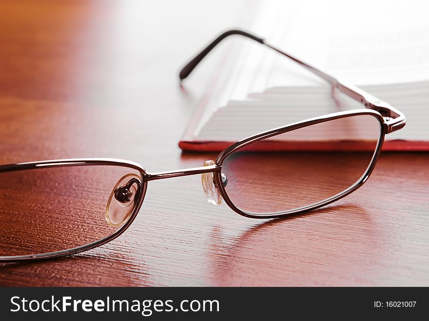 Glasses close up and the open book on a background. Glasses close up and the open book on a background