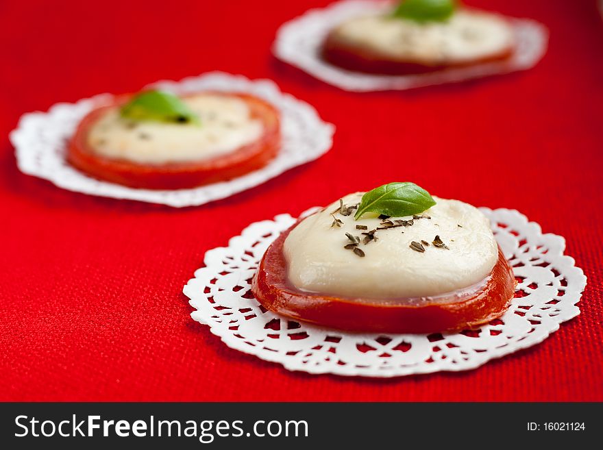 Baked tomatoes and mozzarella served with basil