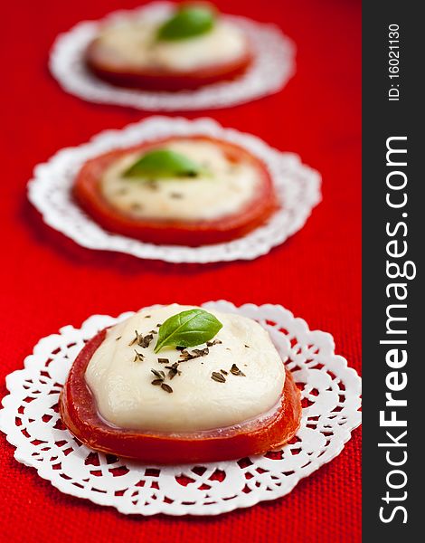 Baked tomatoes and mozzarella served with basil