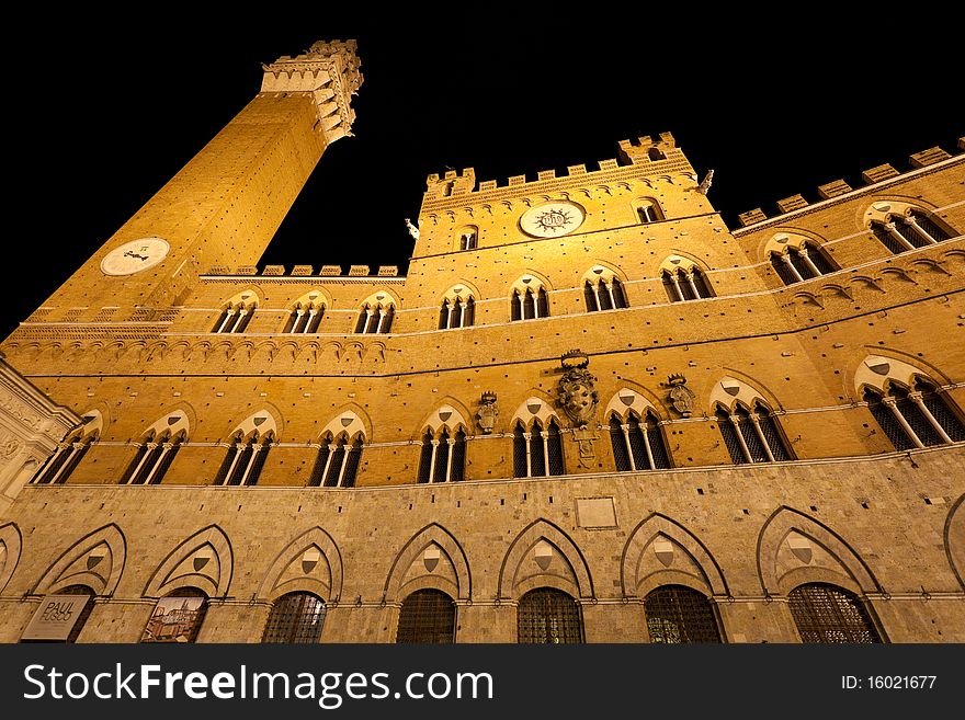 Illuminated Siena tower on Piazza Il Campo, Siena, Tuscany, Italy