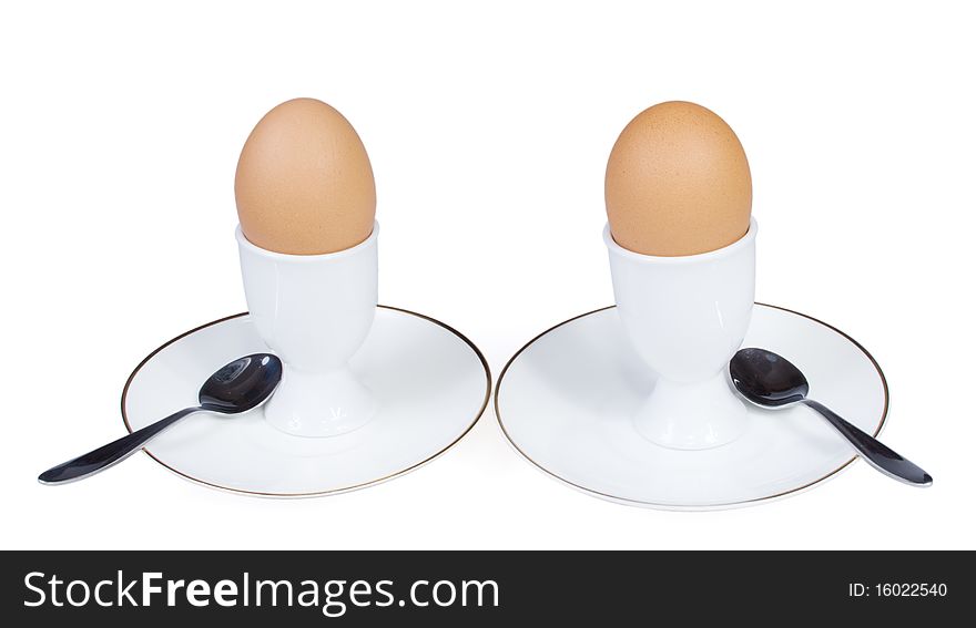 Eggs with spoons are on the white background