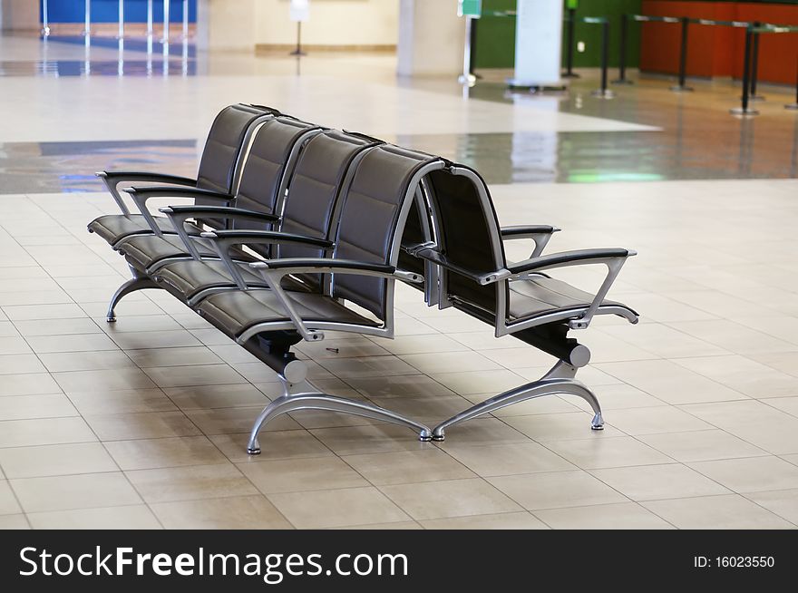 Empty Chairs in waiting area of airport