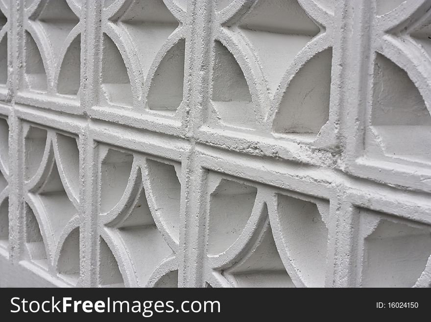 a closeup of an old fashioned white painted wall made from concrete. a closeup of an old fashioned white painted wall made from concrete