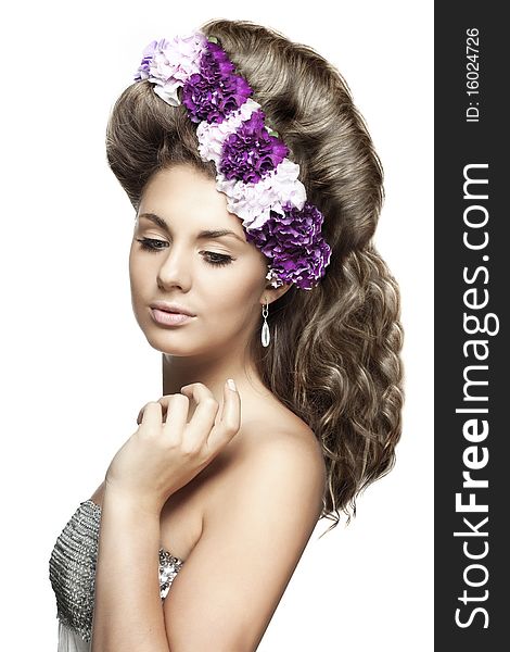 The image of girl with flowers in a beautiful hairstyle