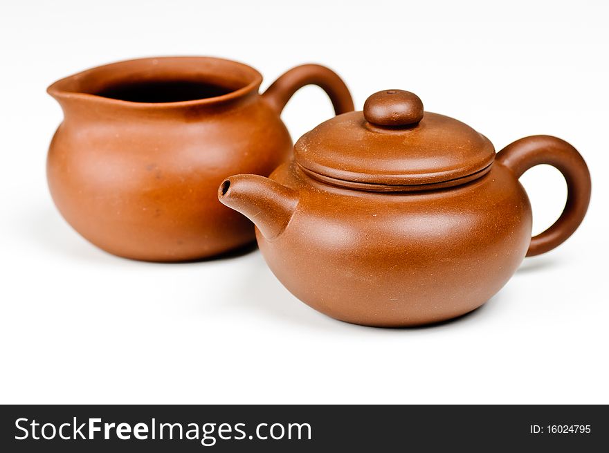 Brown clay tea pots on a white background