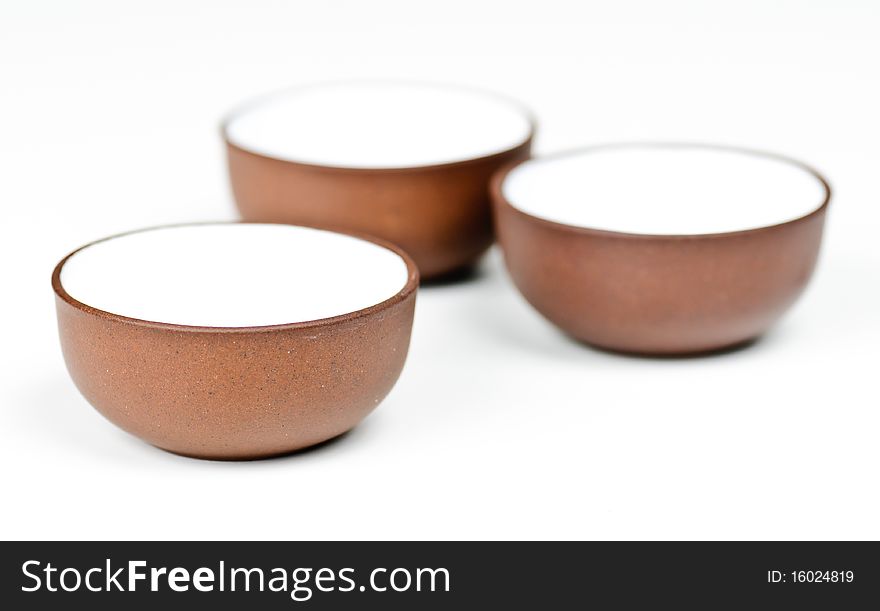 Three clay tea cups on a white background