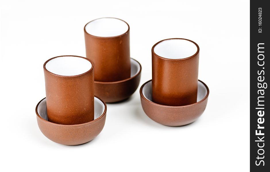 Three clay tea cups on a white background