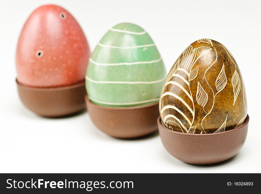 Three stone eggs on a white background