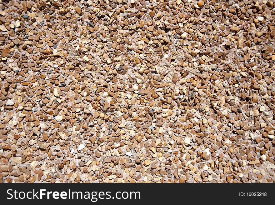 Small gravel sunlit texture background. Small gravel sunlit texture background
