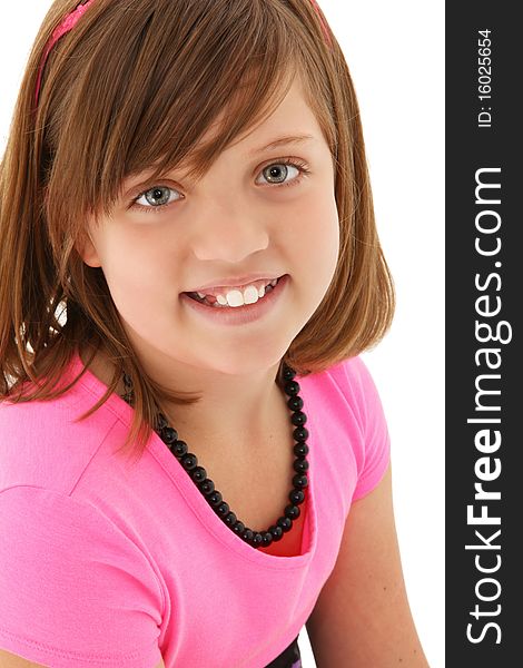 Beautiful 10 year old girl close up head shot over white background.