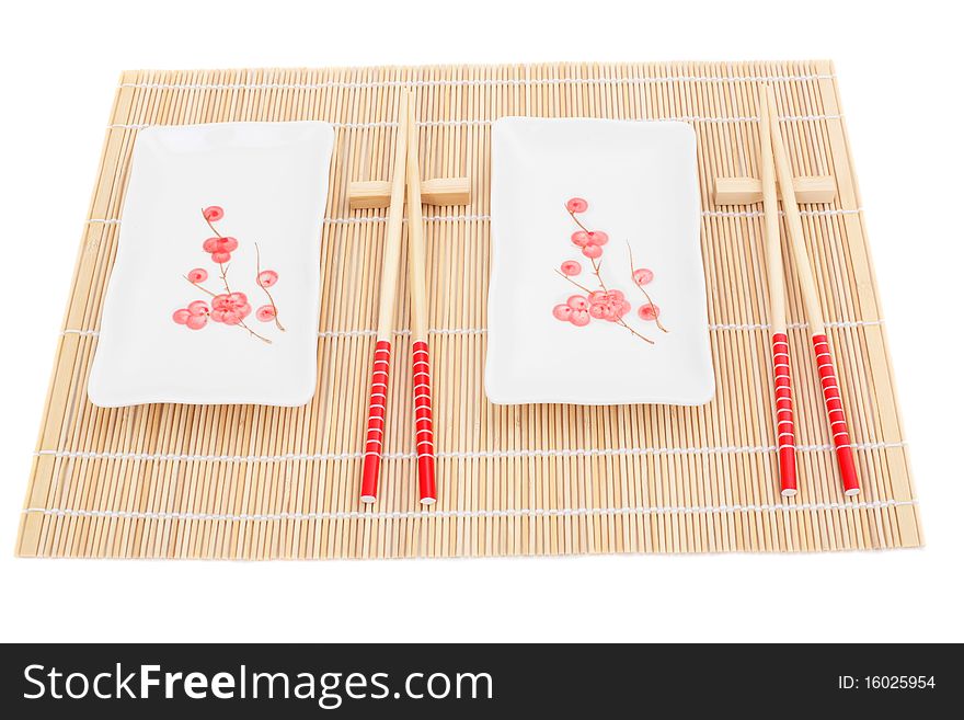 Series. Sushi plates and chopsticks on bamboo mat