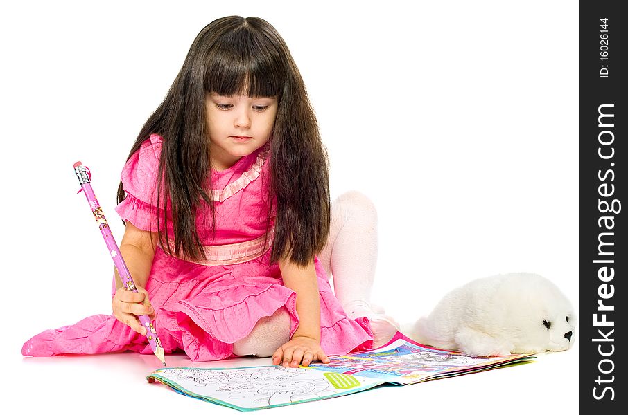 Little girl with pencil lying on floor. isolated