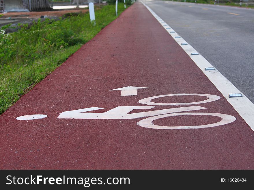 Bicycle lane with white bicycle sign.