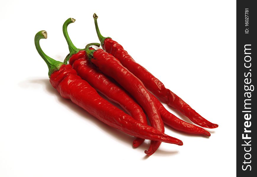 Red chili peppers isolated against a white background. Red chili peppers isolated against a white background