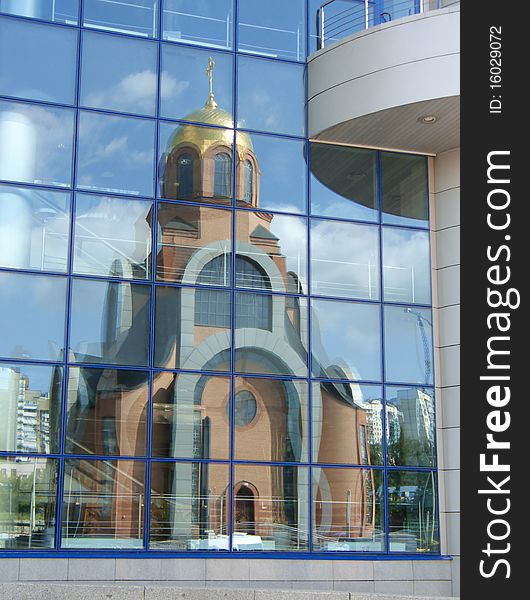 Church Reflexion In Windows Of A Modern Building