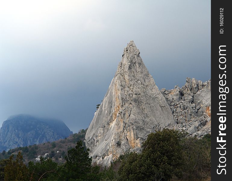 One mountain pyramid a fog on a back background