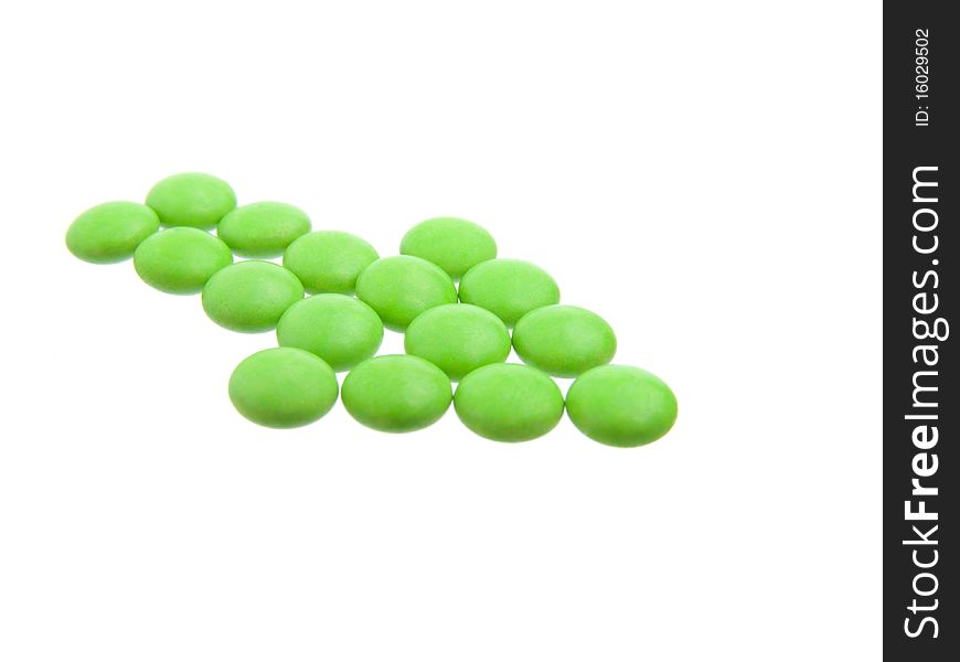 Green tablets in arrow formation, isolated on white background