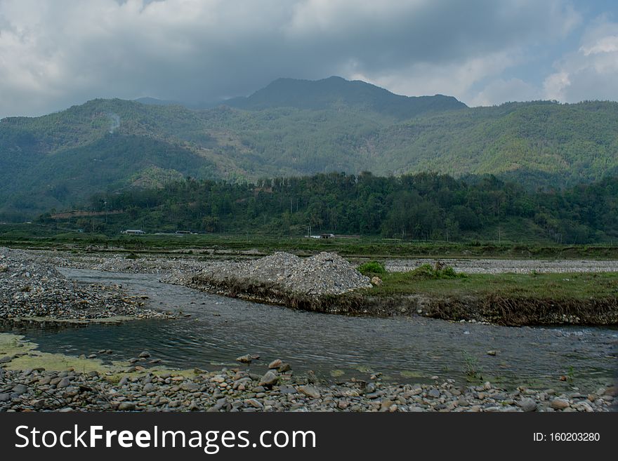 Beautiful landscape of rocky flooded road on the way up into mountains