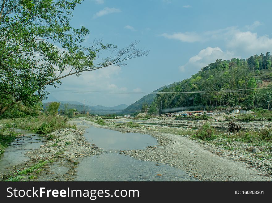 Beautiful Landscape Of Muddy Flooded Road On The Way Up Into Mountains