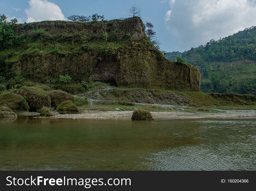 Beautiful landscape view of high green hills above river at Himalaya mountains in Nepal