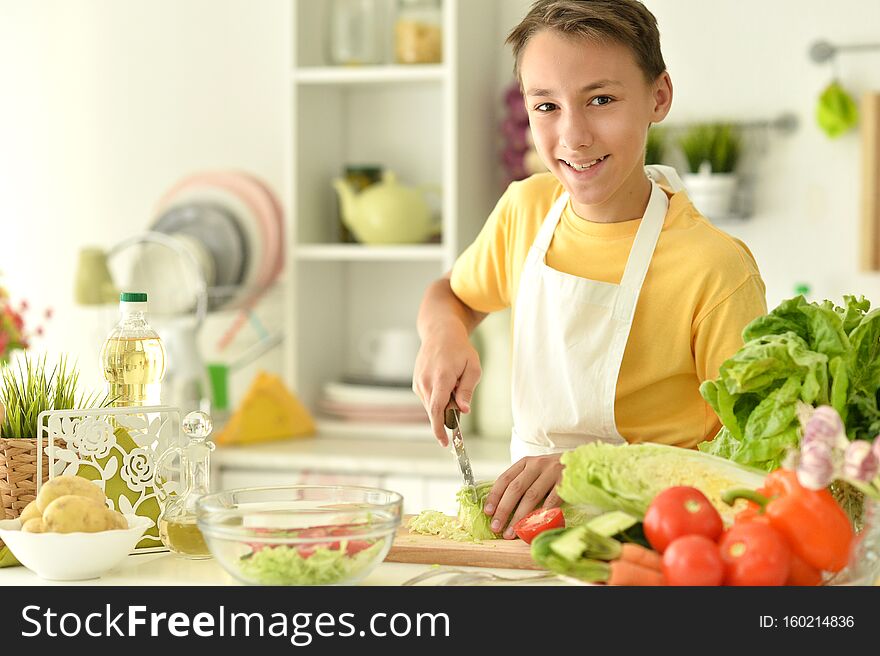 Portrait of cute boy preparing cooking at home